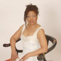 Legendary vocalist Sherry Wilson Butler who also gives professional singing lessons sitting on chair